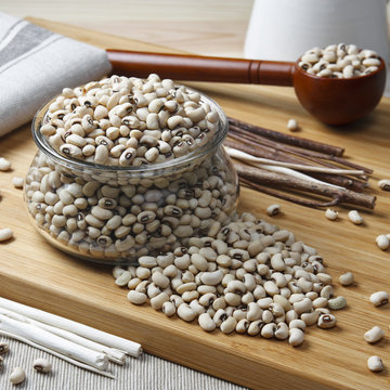 navy bean, white kidney bean or white bean in glass cup on wood