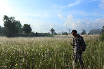 Man and White field grass flower at Thailand