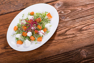 Salad with pumpkin, cheese and mini greens