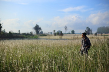 Man and White field grass flower at Thailand