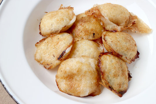 Kind of Thai sweetmeat , thai dessert, Thai coconut pudding. Kanom Krok stuffed with corn on cutting board with wooden table.