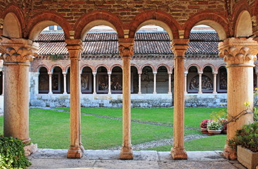 Fototapeta na wymiar Columns and arches in the medieval cloister of Saint Zeno. Verona, Italy - HDR
