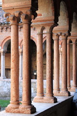 Columns and arches in the medieval cloister of Saint Zeno. Verona, Italy