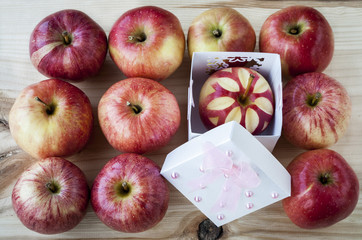ripe red apples on a wooden table
