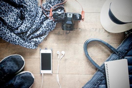Flat lay photography with cellphone, travel accessories, essenti