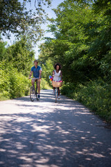 Obraz premium Young multiethnic couple having a bike ride in nature