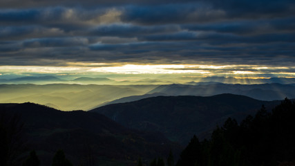 Fototapeta premium Rolling hills and mountains at autumn sunset, view from Bobija mountain, west Serbia