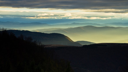 Rolling hills and mountains at autumn sunset, view from Bobija mountain, west Serbia