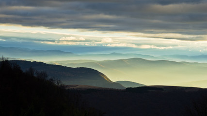 Rolling hills and mountains at autumn sunset, view from Bobija mountain, west Serbia