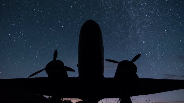 Stars Sky Turning over Vintage Military Aircraft Time Lapse - Astrophotography of Night Sky with Milky Way Galaxy - 4K 3840 x 2160
