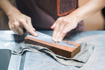 sharpening the knife with whetstone
