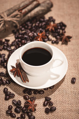 Coffee cup and coffee beans on table