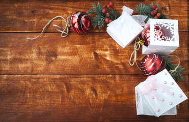 Christmas gifts, red balls on the wooden table