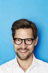 Portrait of guy in glasses, studio