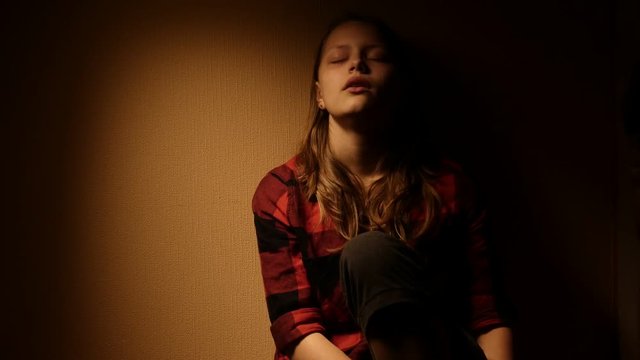Teen girl. Drug addiction. Depressed face of a teen girl with overdose or hangover-abstinence syndrom from drugs. 4K
