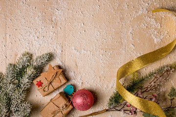 Christmas decoration background: Pine and holly branches, handmade gifts with labels, cardboard...