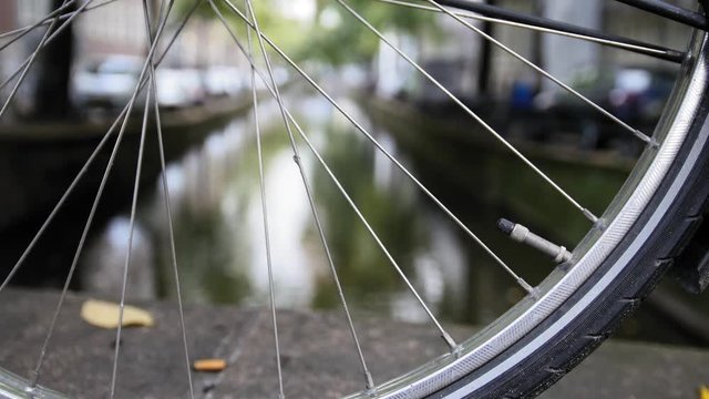 Details of bicycle wheel at Amsterdam canal, Autumn, Netherlands