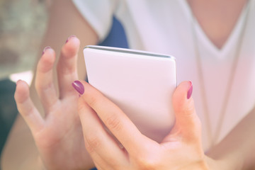 Using cellphone outdoors. Shallow depth of field