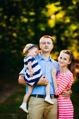 Fototapeta premium The parents embracing a little daughter