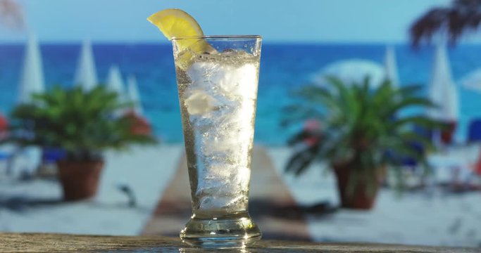 icy and refreshing cocktails are served on a bar on the beach by the sea or the pool in slow motion