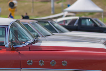 Close-up of an old car. Part of the exterior. An American classic. Chrome lining. Glass with reflection.