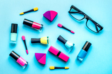 concept cosmetic set on blue background top view