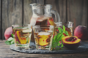 Cold healthy tea with peaches and mint
