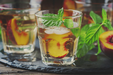 Cold healthy tea with peaches and mint