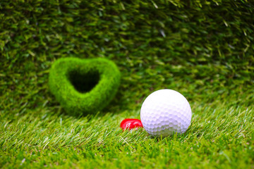 golf ball with green grass heart shape on green course