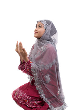 Young asian women muslim wearing red jijab praying isolate on white background