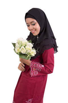 Young asian women muslim wearing red jijab holding flower in hand
