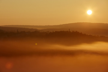 autumnal foggy sunrise