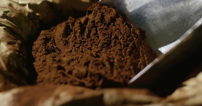 Super slow motion macro of cocoa powder dosage (close up)