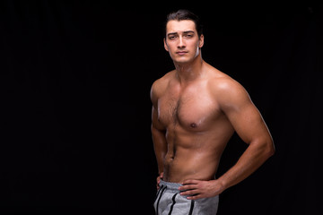 Fototapeta premium Ripped muscular man on black background