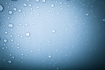 Drops of water on a color background. Blue. Toned