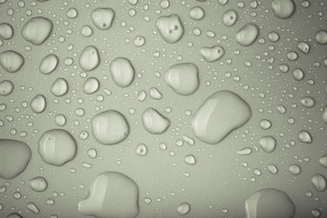 Drops of water on a color background. Gray. Toned