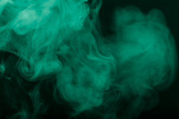 Cloud of smoke on black background. Selective focus. Toned