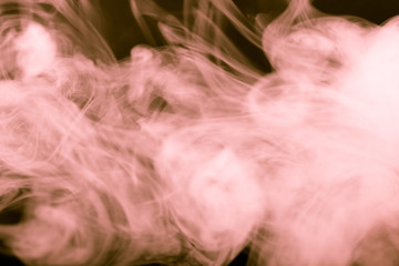 Cloud of smoke on black background. Selective focus. Toned