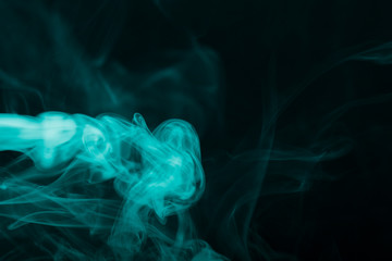 Cloud of smoke on black background. Selective focus. Toned