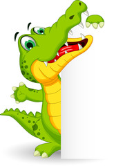 Fototapeta premium funny crocodile cartoon posing with blank sign