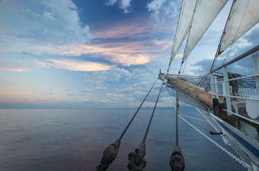 The nose of a sailing ship at sunrise