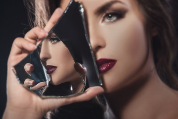 Beautiful woman with a shards of mirror