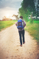 Close up young hipster man with backpack on his shoulder walking