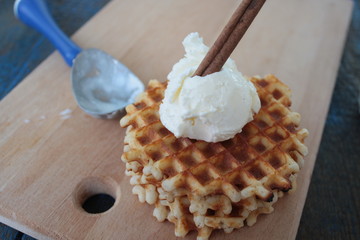 waffles with ice cream and milk, cinnamon, anise on blue wooden background. a magical dessert for Christmas
