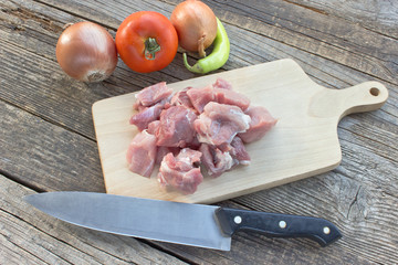 Chopped pork meat for goulash on wooden board