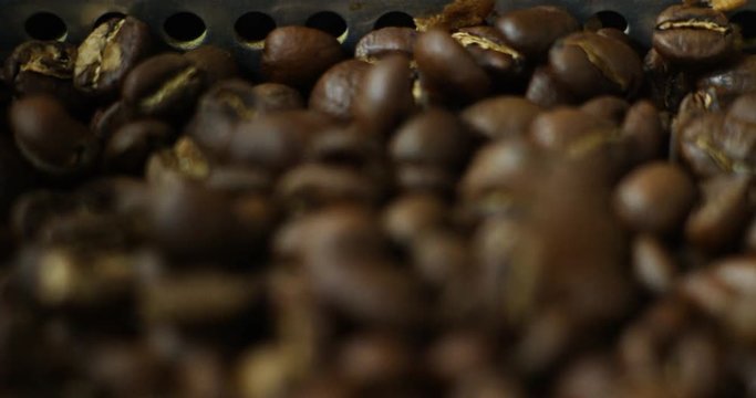 the raw coffee beans in the professional roasting, grilling at the right temperature in slow motion. concept of perfect coffee, Italian and Ethiopian roasting, nature and food.