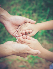 Close up of father holding his daughter hand, so sweet,family ti