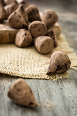 Homemade chocolate truffles on wooden table

