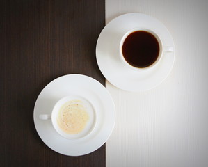 Two cups of black and white coffee