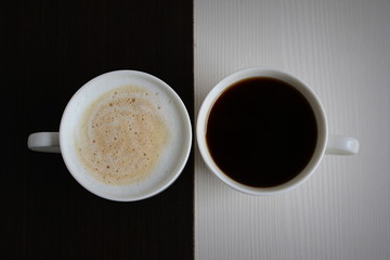Two cups of black and white coffee